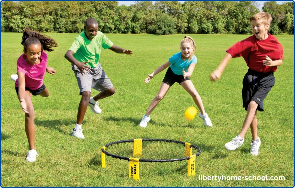 15 PE Games for 10-Year-Olds at Home 14 Children playing spikeball, hitting a ball on a small round net with energy