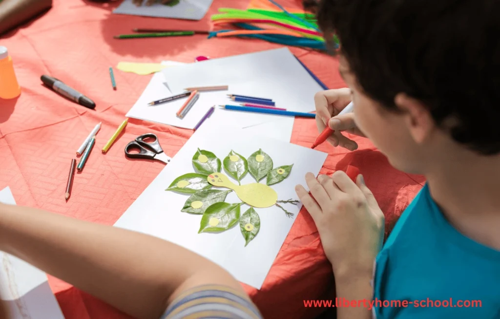 10 Summer Activities for Kids 3 Young child making a nature collage using leaves, flowers, and sticks on a sheet of paper outdoors
